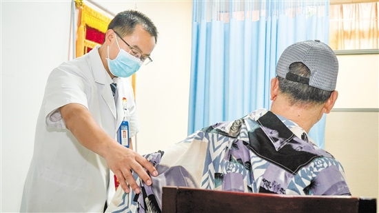 皮膚科醫(yī)生為來診患者檢查身體。