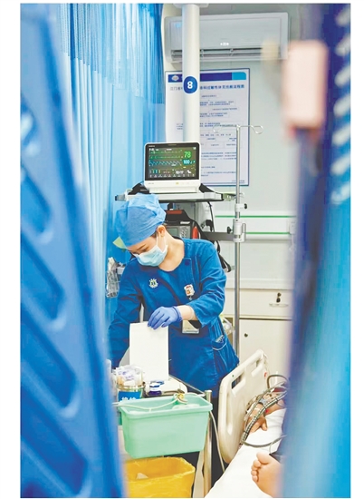 這是一雙爭分奪秒的手。急診搶救室是與時(shí)間賽跑的“生命戰(zhàn)場”，收治的都是急危重癥患者，生死往往就在一瞬間。面對心梗病人，江門市中心醫(yī)院急診科護(hù)士譚秀娟正專心致志地為患者做心電圖檢查，用專業(yè)與仁心守護(hù)生命之光。